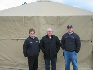 Janice, Herb and Jeff Grieshop stand in front of tent like the ones that Celina Tent Inc. will make for the United States government to supply shelters for U.S. military and federal civilian agencies.<br></br>dailystandard.com