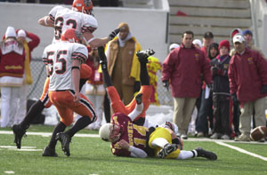 Coldwater Ryan Geier, on ground in back, sacks Youngstown Mooney quarterback Tony Brunetti, 14, and forces a fumble as Cavalier teammates Gaston Pleiman, 82, and Cody Muhlenkamp, 55, trail on the play. Pleiman scooped up Brunetti's fumble and returned it 70 yards for a touchdown on Saturday in the Division IV state final at Canton's Fawcett Stadium. The fumble return for a touchdown put the Cavaliers ahead 13-3 and Coldwater went on to win its first state football title with a 33-9 victory over Mooney.<br></br>dailystandard.com