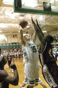 Celina's Scott Luthman, 15, tries to shoot over a Linden McKinley defender during their game on Saturday night. Celina fell to 0-2 on the young season with a 57-45 defeat to Linden McKinley.<br></br>dailystandard.com