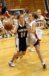 Parkway's Marian Bevington, 11, tries to make a pass along the baseline past a Shawnee defender during their game on Tuesday night. Shawnee defeated Parkway, 75-33.<br></br>dailystandard.com