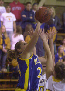 St. Marys' Stephanie Platt, in blue, shoots over a pair of Delphos St. John's defenders during their game on Monday night at Arnzen Gym. St. John's defeated St. Marys, 52-45.<br></br>dailystandard.com