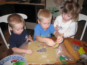 Too many young bakers don't ruin the Christmas cookies according to proud Grandma Anne Larger of Minster. Shown cutting out favorite shapes are brothers Austin Larger, 3, left, Jacob Larger, 4, and their first cousin, 3-year-old Katie Larger, all of Minster.<br></br><br></br>dailystandard.com