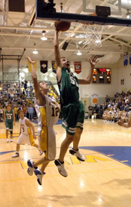 Celina's Andy Muhlenkamp, right, drives strong to the basket while St. Marys' Mark Riesen, 12, tries to make a defensive play during their game on Friday night. Muhlenkamp was the lone player in double figures for Celina with 12 points in the eight-point loss.<br></br>dailystandard.com