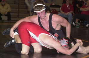 Coldwater's Ross Jansen, top, puts the final touches on a 6-4 triumph against Wapakoneta's Tyler Shipp, in red, during their wrestling dual match on Tuesday night at the Palace. Coldwater won the first-ever meeting between the two schools with a 42-21 victory.<br></br>dailystandard.com