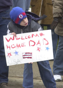 Donovan Carmean, 8, of Van Wert, looks down East South Street in St. Marys anticipating the arrival of charter buses carrying his dad, Cory, and 120 members of the Ohio National Guard unit. <br></br>dailystandard.com