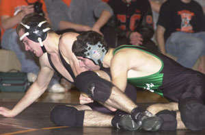 Celina's Eric Braun, right, tries to tighten his grip on Coldwater's Andy Schmidt, left, during their 152-pound match on Tuesday night at The Palace. Coldwater went 2-0 on the night defeating both Celina and Urbana in dual matches.<br></br>dailystandard.com