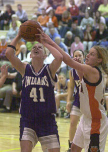 Fort Recovery's Tiffany Gaerke, 41, scores two of her game-high 15 points against Minster on Thursday night. Gaerke added 12 rebounds in the Indians' 49-31 victory.<br></br>dailystandard.com
