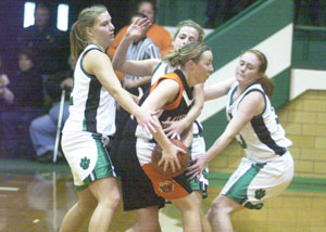 Minster's Nikki Wente, with ball, gets surrounded by Celina's Liz Homan, left, Meg Smalley, back, and Betsy Hone, right, during their nonconference game on Saturday afternoon. Minster went on to defeat Celina, 43-38.<br></br>dailystandard.com