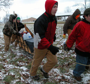 Members of Boy Scout Troop 98 of Rockford pull their homemade dog sled across the snow-covered course of the Klondike Derby held at the Allen County Fairgrounds in Lima on Saturday. The troop placed in the top 10 of the 40-plus units participating from 13 area counties. Troop 101 of St. Henry excelled at the seven skill stations and took first place in the contest.<br></br>dailystandard.com