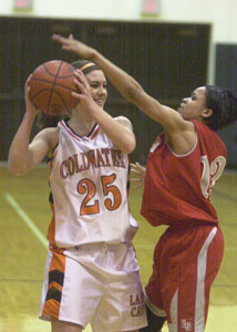 Coldwater's Jessica Bettinger, 25, tries to fend off a Lima Senior defender during their game on Tuesday night. Bettinger's Cavaliers defeated the Spartans, 82-51.<br></br>dailystandard.com