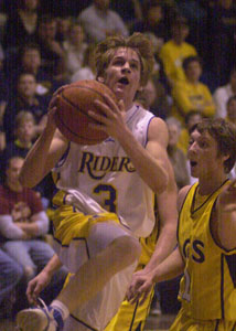 St. Marys' Doug Burke, with ball, goes strong to the basket for two points during the Roughriders' game against Ottawa-Glandorf on Friday night. The Titans beat the Roughriders, 54-45.<br></br>dailystandard.com