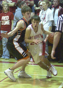 St. Henry's Ryan Ranly, right, drives past Mike Lefeld, left, during their Midwest Athletic Conference matchup on Friday night at Redskin Gymnasium. St. Henry defeated Coldwater, 58-38.<br></br>dailystandard.com