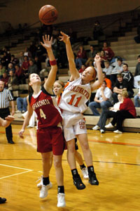 Celina's Amy Harner, with ball, tries to split the Fort Recovery double team made up of Holly Stein, 32, and Vicki Roessner, right, on Tuesday night at Fort Site Fieldhouse. Fort Recovery defeated Celina, 57-37.<br></br>dailystandard.com