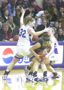 Coldwater's Renee Hemmelgarn, 11, tries to draw a foul while shooting over Wapakoneta's Lindsey Kentner, 4, during their game on Tuesday night at The Palace. Wapakoneta defeated Coldwater 50-42 behind a game-high 25 points from Kentner.<br></br>dailystandard.com