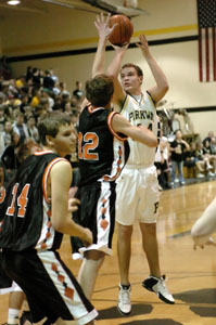 Parkway's Mark Snyder, with ball, shoots over Versailles' Jayson White, middle, while the Tigers' Jordan Liette, 14, looks for someone to box out during their game on Friday night. Versailles went on to knock off Parkway, 66-54.<br></br>dailystandard.com