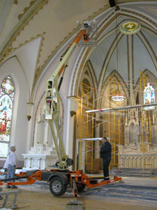 Workers use a boom lift to work near the ceiling of St. Sebastian Church. The Catholic congregation is nearing the end of a five-year renovation plan that forced the removal of pews for replastering of cracks and interior painting. Masses normally scheduled at the church are being held at St. John the Baptist Church in Maria Stein. See story on page 9A.<br></br>dailystandard.com