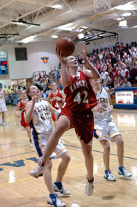 New Knoxville's Nicole Wright, 42, scores two of her game-high 18 points in front of Marion Local's Katelyn Mescher, 40, and Megan Barhorst, right, during Midwest Athletic Conference action at The Hangar on Thursday night. Wright and the Rangers won the MAC outright with a 45-30 victory over Marion Local.<br></br>dailystandard.com