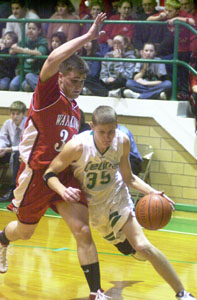 New Bremen's Scott Brackman, with ball, splits Minster's Max Phlipot, left, and Jimmy Stechschulte, right, during their game on Friday night at Cardinal Gymnasium. Brackman scored 17 points to  help the Cardinals to their first-ever outright Midwest Athletic Conference title with a 59-41 victory over rival Minster.<br></br>dailystandard.com