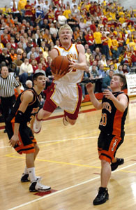 Celina's Eric Loughridge, with ball, tries to drive baseline past Wapakoneta defender Brandon Steinke during their Western Buckeye League contest at The Fieldhouse on Friday night. Wapak defeated Celina, 60-46.<br></br>dailystandard.com