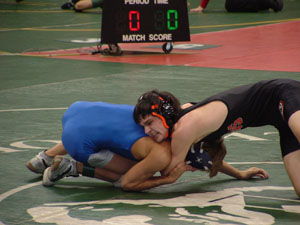 Coldwater's Kenny Platfoot, right, gets a tight grip on Tiffin Calvert's Ricky Headrick, in blue, during a 125-pound match at Division III state wrestling meet in Columbus. Platfoot won 11-0 to advance to today's competition in the winner's bracket.<br></br>dailystandard.com