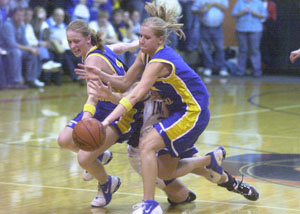 Fort Recovery's Holly Stein, middle, gets sandwiched between Marion Local's Maria Moeller, left, and Holly Fortkamp, right, during their Division IV district final contest at Coldwater on Saturday. Marion Local defeated Fort Recovery 53-46 to earn a berth at the Vandalia-Butler regional.<br></br>dailystandard.com
