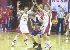 New Bremen's Allan Webster, 20, and teammate Scott Steineman, right, double team an Ada ball handler during the Division IV district final at Wapakoneta on Friday night. The Cardinals' press caused fits for Ada as the Bulldogs, the second-ranked team in the state, turned the ball over 20 times in the game. New Bremen defeated Ada, 72-44.<br></br>dailystandard.com