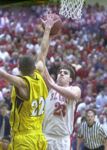 St. Henry's Mitch Niekamp, 23, shoots over Ottawa-Glandorf's Alex Gerschutz, 22, during their Division IV district final contest on Saturday night at Ohio Northern University. St. Henry defeated Ottawa-Glandorf, 67-50.<br></br>dailystandard.com