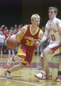 New Bremen's Scott Brackman tries to dribble past Houston's Matt Mullen during a game on Tuesday night. Mullen helped make it a tough night for Brackman and the Cardinals.<br></br>dailystandard.com