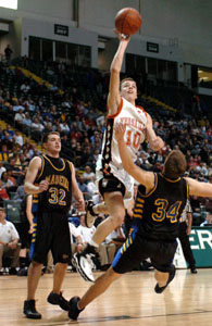 Versailles' Jeremy Shardo, 10, shoots the ball while Madeira's David Nichols, 34, tries to draw a charge during their Division III regional semifinal contest on Wednesday night.<br></br>dailystandard.com