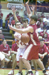 St. Henry's Mitch Niekamp, right, and Ryan Ranly, back, put defensive pressure on Johnstown-Monroe's Matt DiBlasio, in white, during their Division III regional semifinal on Wednesday night.<br></br>dailystandard.com