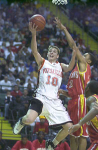 Versailles guard Jeremy Shardo, 10, scores two points in front of North College Hill's Dwayne Parks, right, during their Division III regional final contest at Wright State University on Saturday.<br></br>dailystandard.com