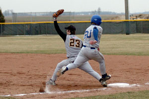 St. Marys' Brett Baker, 20, kicks up some chalk on his way to first base where he is out by a step as Parkway's Jensen Painter, 23, catches the ball. Parkway slipped past St. Marys, 3-1.<br></br>dailystandard.com