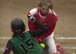St. Henry catcher Brenda Hemmelgarn, right, blocks the plate from Celina's Allison Braun, 15, during their softball game on Monday. Celina defeated St. Henry, 10-0.<br></br>dailystandard.com