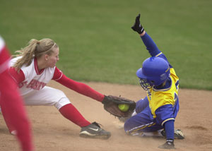 St. Marys' Toya Anderson, right, makes a great slide around the glove of St. Henry's Bethany Puthoff, left, during their contest on Thursday afternoon. St. Marys went on to defeat St. Henry 6-5 with three runs in the seventh inning.<br></br>dailystandard.com