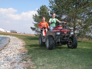 Lillian Roessner and her brother, Andy, ride their four-wheeler in the back of their property along Siegrist-Jutte Road in rural Coldwater. The siblings' parents, Dale and Diane Roessner, taught their children how to ride the ATV safely to avoid accidents. ATV safety classes are held in some areas such as one offered by Honda of America at the Troy Rider Education Center, 101 S. Stanfield Road.<br></br>dailystandard.com