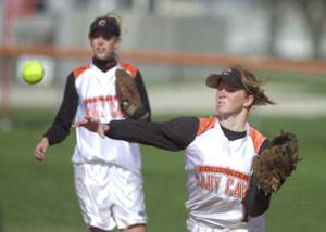 Coldwater's Renee Hemmelgarn, right, throws the ball to first base for an out during the Cavaliers' Midwest Athletic Conference matchup against Versailles on Monday afternoon. Coldwater defeated Versailles, 2-1.<br></br>dailystandard.com