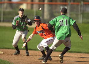 Coldwater baserunner Brady Geier, middle, gets caught in a rundown between first and second base with Celina's Scott Luthman, left, and Eric Loughridge, right, on Monday afternoon at Veterans Field. Coldwater defeated Celina, 8-2 in a Mercer County matchup.<br></br>dailystandard.com