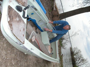 Craig Morton, manager of Grand Lake St. Marys State Park, shows the extreme damage -- including missing floor boards -- sustained to a boat that was towed in from Safety Island several weeks ago. The boat's occupants, three area men, were stranded on Safety Island overnight when their boat drifted off course in high winds.<br></br>dailystandard.com