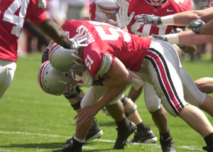 Ohio State freshman linebacker Ross Homan, 51, tackles Buckeye quarterback Todd Boeckman, in white, during the Ohio State spring game on Saturday. Homan, of Coldwater, and Boeckman, of St. Henry, played very well at times in the final spring practice for the Buckeyes.<br></br>dailystandard.com