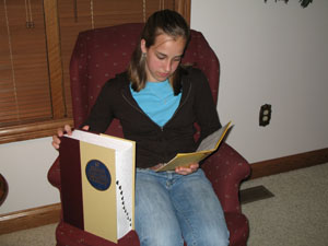 Megan Schaefer, an eighth-grader at Marion Local Schools, uses two study tools as she prepares for her second trip to the national spelling bee. She displays the large dictionary national spellers use and the smaller Paideia, which prepares students for school, county and regional events.<br></br>dailystandard.com