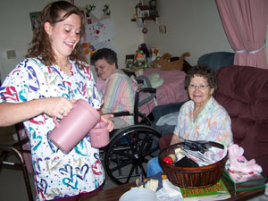 Beth Fortkamp of Fort Recovery fills a water cup for her grandmother, Mildred Dues, at Briarwood Manor, Coldwater. Fortkamp has joined the Army and hopes to some day work in health care.<br></br>dailystandard.com