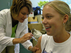 Amanda Smith, 18, receives a meningitis vaccination from Mercer County-Celina City Health Department Nursing Director Sally Bowman at Celina High School on Monday. The program was sponsored by the Celina Rotary Club which helped defray half the cost of the immunizations for Celina High School seniors heading off to college in the fall.<br></br>dailystandard.com