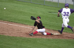 New Bremen's Matt McCollum makes the stretch at first base to catch the ball as Fort Recovery's Clint Tobe, 32, tries to beat the throw in the fifth inning of Friday's Division IV district semifinal at Minster. New Bremen won, 4-3, to advance to todays district final at Coldwater.<br></br>dailystandard.com