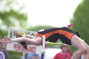 Minster's Ashley Meiring looks back after clearing the bar during the high-jump competition on Wednesday at the Division III regional track meeet at Piqua. Meiring qualified for state in the high jump with a second-place finish and helped the Wildcats to a first-day lead with 23 team points.<br></br>dailystandard.com