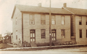 The old Schaffer house at 163 N. Main St. in Minster is shown in the early 1900s. Julia Schaffer stands with daughters Aggie and Florence in front of the house which is being razed. Florence's children, Jim Boyle and Julia Boyle Unger, made one final visit and came away with a few mementos including old doors.<br></br>dailystandard.com