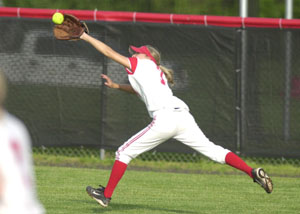 St. Henry's Janel Bruns stretches to try and snag a fly ball during Friday's Division IV Regional semifinal against West Liberty-Salem. The Tigers beat the Redskins 7-3.<br></br>dailystandard.com