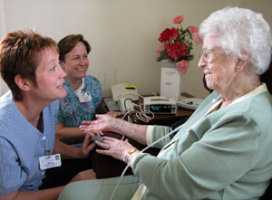 Mary Ann Gebele of Coldwater goes through a trial run of her new Honeywell HomMed telemonitor with Mercer Health Home Care nurses Stacy Schwieterman, left, and Cindy Hemmelgarn. The monitor, the first of its kind in the local area, allows an in-home patient to easily record their own vital signs and send them electronically to medical personnel.<br></br>dailystandard.com