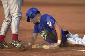 Grand Lake lead-hitter Ryan Chenowith, right, is safe at third on a stolen base attempt in the first inning as the Mariners took on the Portland Rockets in an exhibition contest on Thursday night at Jim Hoess Field. Chenowith stole four bases to help lead the Mariners to an 8-2 victory. The Mariners start the regular season tonight at home.<br></br>dailystandard.com