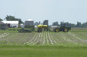 A John Deere air seeder planter sits in a field near Mercer in the northern part of the county on Monday. Many area farmers have had to replant their corn and soybeans, some of them twice, this year due to prolonged, cold, wet weather. Many others wanting to replant soybeans in recent days have been unable to because their fields are too wet.<br></br>dailystandard.com