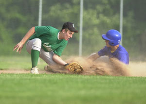 St. Marys' Mitch Dunlap, right, slides safely into third base just ahead of the tag from Celina's Keith Neighbors during their ACME contest Thursday night at Eastview Park. Celina won a wild one over St. Marys, 14-13.<br></br>dailystandard.com